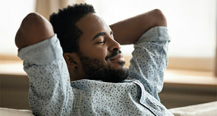 Icon of a man leaning back in a chair and contemplating seeking substance use treatment