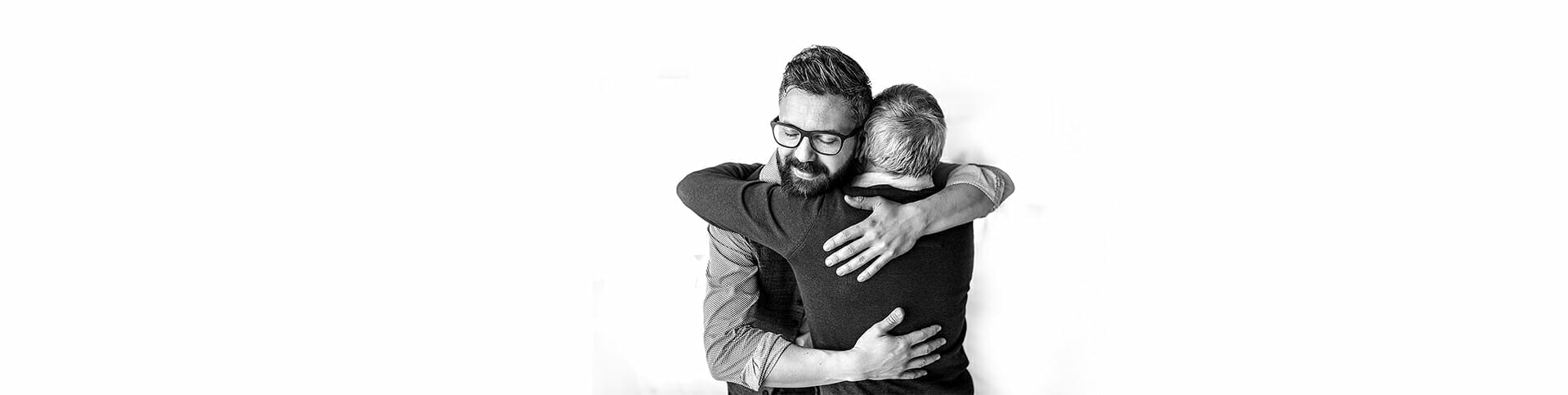 Image of a father and son hugging, representing helping a loved one with substance use disorder