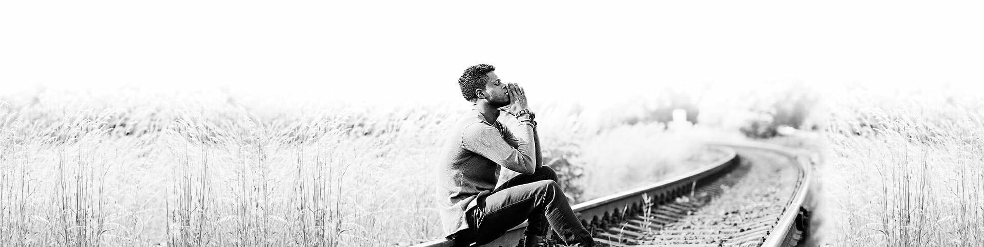 Image of a man meditating outside