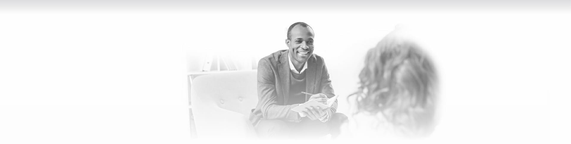 Image of a therapist speaking with a client about substance use treatment options