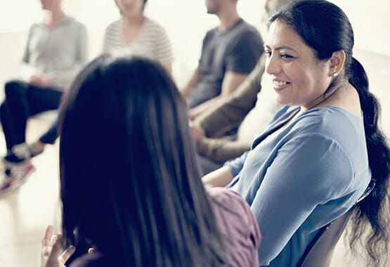 Image of two women having a discussion at an SUD treatment center