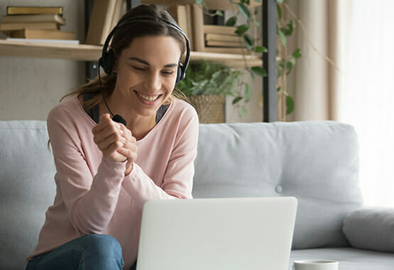 Image of a woman with a headset and computer providing support for substance use disorder treatment